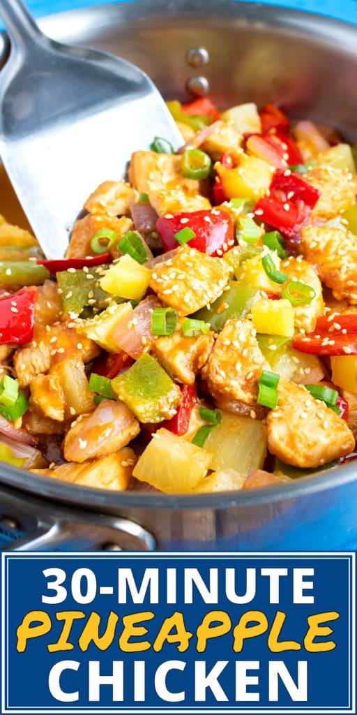 A skillet full of cubed chicken and vegetables in a sticky pineapple sauce.