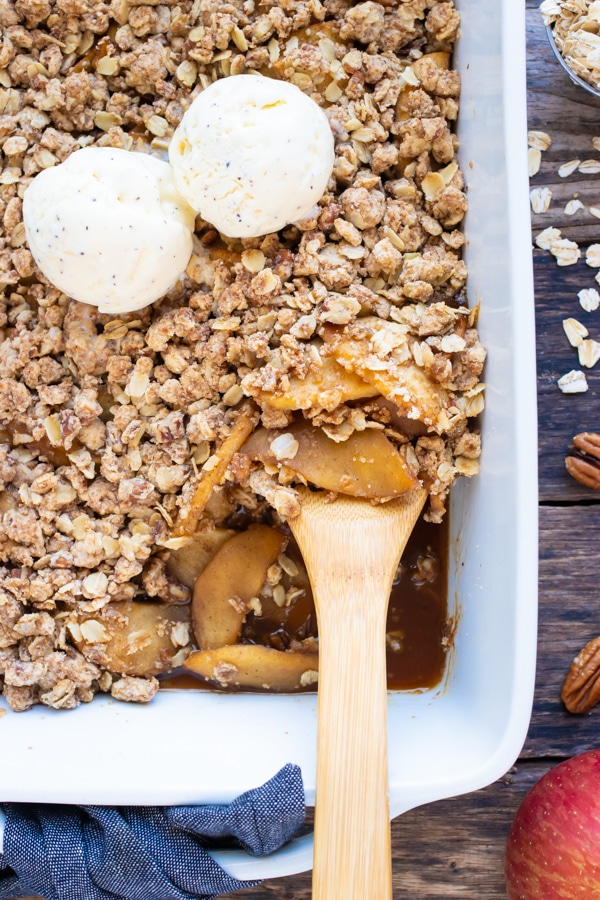 A healthy and gluten-free apple crisp recipe with two scoops of ice cream in a baking dish.