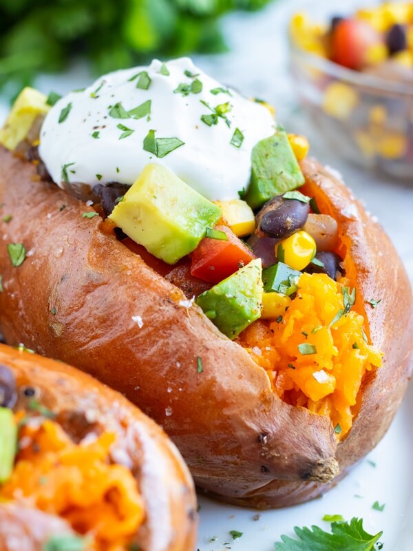 Taco stuffed sweet potatoes with black beans and corn for a vegan dinner recipe.