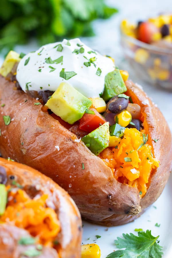 Taco stuffed sweet potatoes with black beans and corn for a vegan dinner recipe.