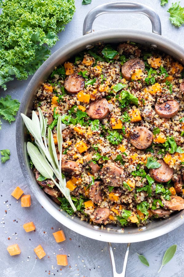A Fall-inspired healthy quinoa recipe with sage, sweet potatoes, chicken apple sausage, and kale.