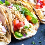 Healthy, easy, and gluten-free chicken taco recipe with corn tortillas, tomatoes, and avocado.