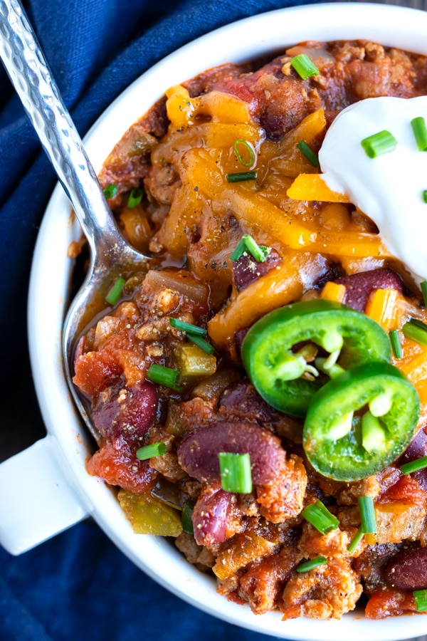 A silver spoon in a bowl full of healthy, gluten-free, and dairy-free turkey chili.