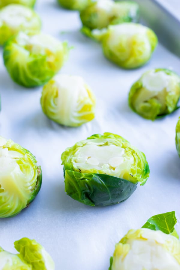 A smashed Brussels sprout on a baking sheet.