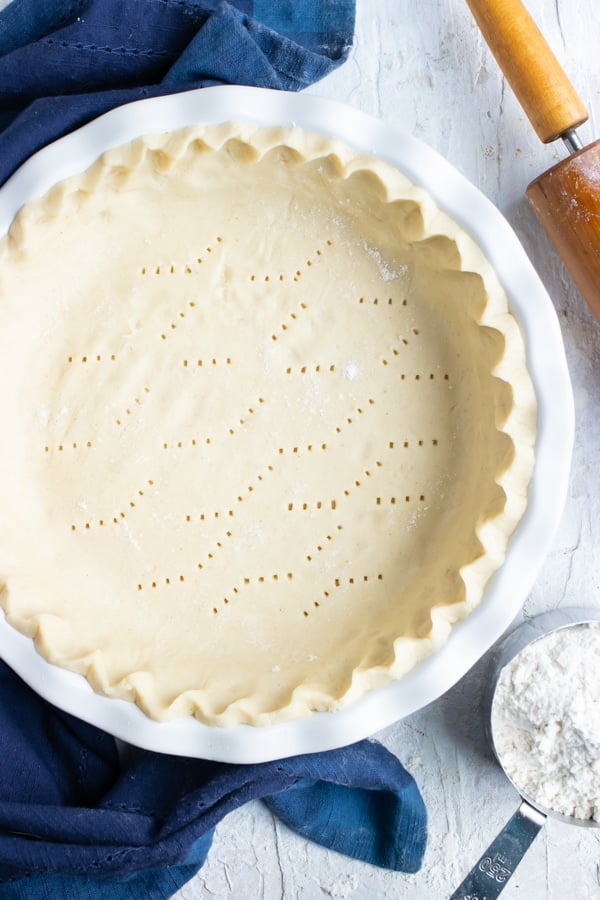 A rolling pin and a cup of flour next to an easy crust recipe for sweet or savory pies.