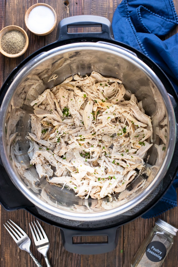 AndA 6-quart Instant Pot that is full of one pound of shredded chicken.