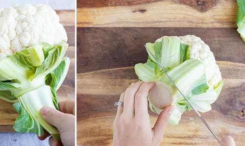 Trimming and removing the green leaves from a head of cauliflower.