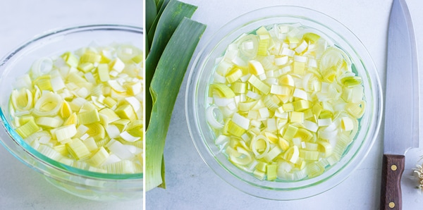 A bowl full of water showing how to clean leeks.