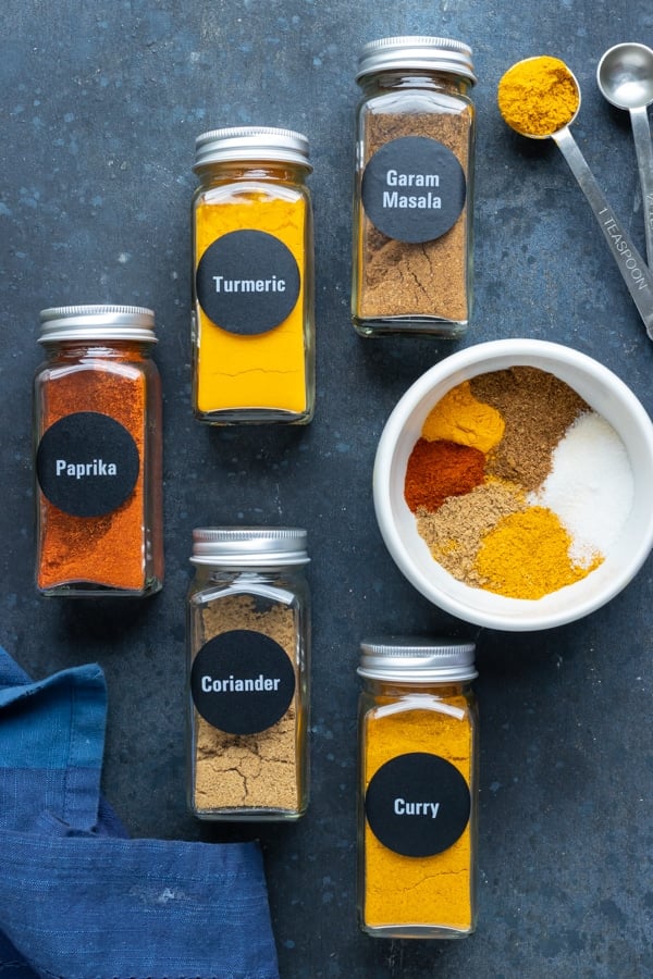 Garam masala, curry powder, paprika, coriander, and turmeric as the ingredients in a homemade curry seasoning recipe.