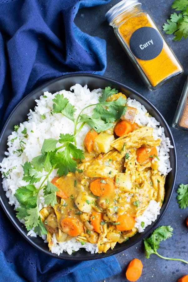 Instant Pot Chicken curry that is served on a bed of basmati rice.
