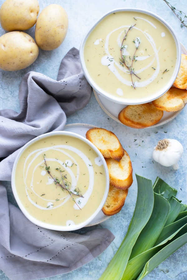 Two bowls of a creamy potato leek soup that is quick, easy, and healthy to make.