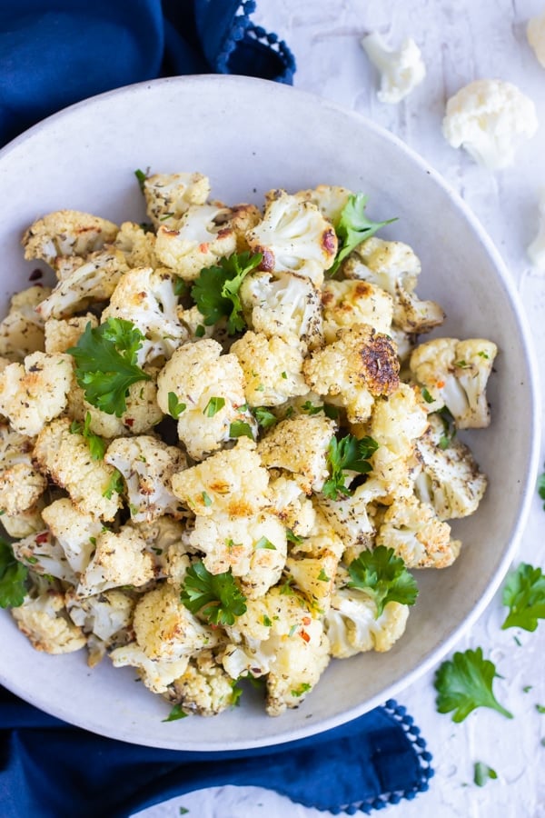 A large white bowl of a quick and easy roasted cauliflower recipe.