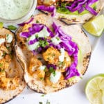 Vegan tacos that are full of roasted cauliflower, shredded red cabbage, avocado, and a cilantro lime sauce.