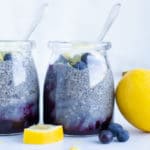 A glass jar full of a blueberry lemon breakfast recipe made from chia seeds.