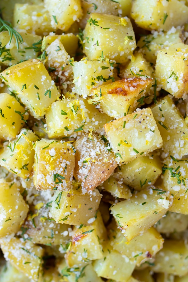 Lemon Dill roasted potatoes with Parmesan cheese on a large baking sheet.