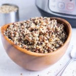Fluffy quinoa that was cooked in an Instant Pot in a wooden bowl.