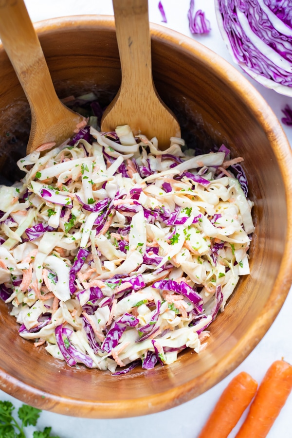 A wooden bowl full of a southern coleslaw recipe.