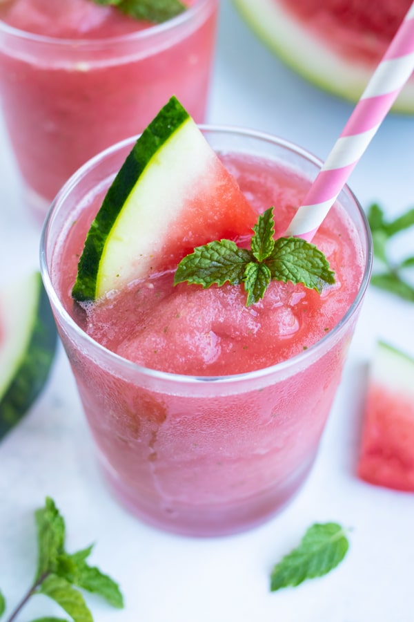 Watermelon Frozen Rosé with mint in a cocktail glass with a pink paper straw.