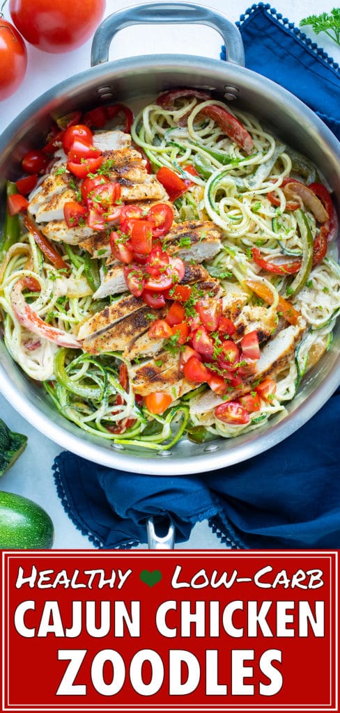 A skillet holds zucchini noodles, sauteéd bell peppers and cajun chicken for an easy and healthy dish.
