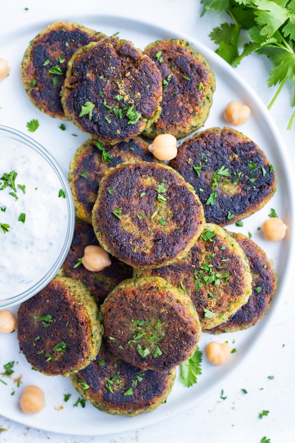 Healthy falafel is plated with tzatziki sauce for a Mediterranean dish.