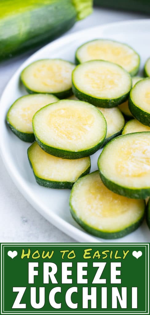 Frozen zucchini is stacked on a white plate on the counter.