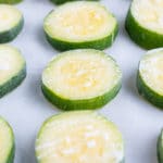 Learn how to freeze zucchini by placing sliced zucchini on a baking sheet to be frozen after cooking and shocking.