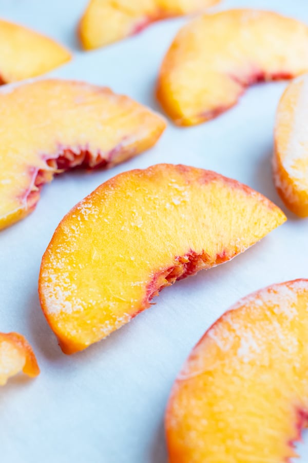 Frozen peaches are placed flat and spaced apart after being put in the freezer.