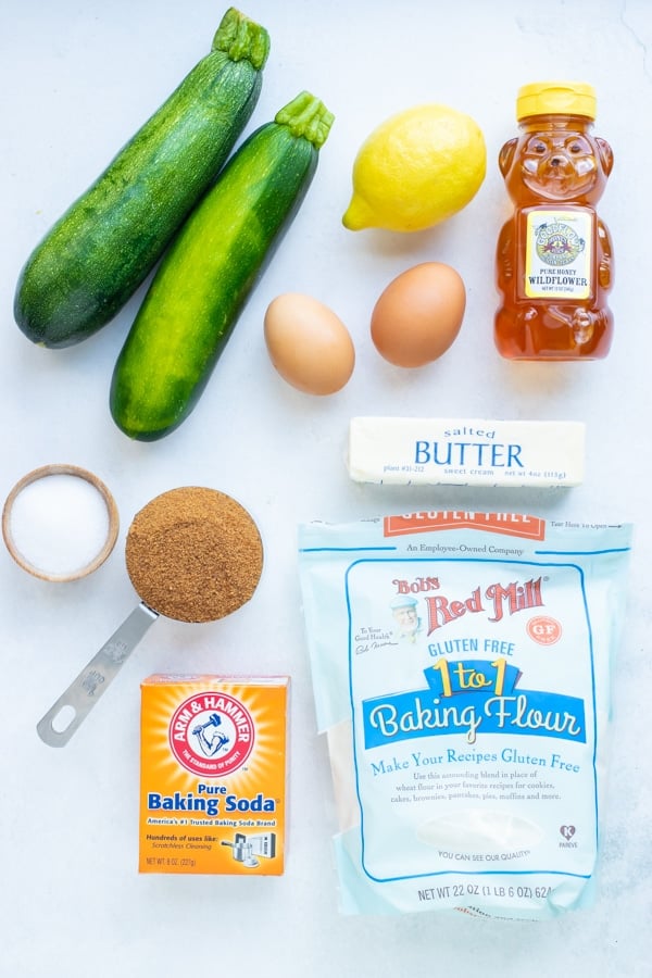 Zucchini, lemon, honey, and gluten-free flour for a Lemon Zucchini Bread recipe.