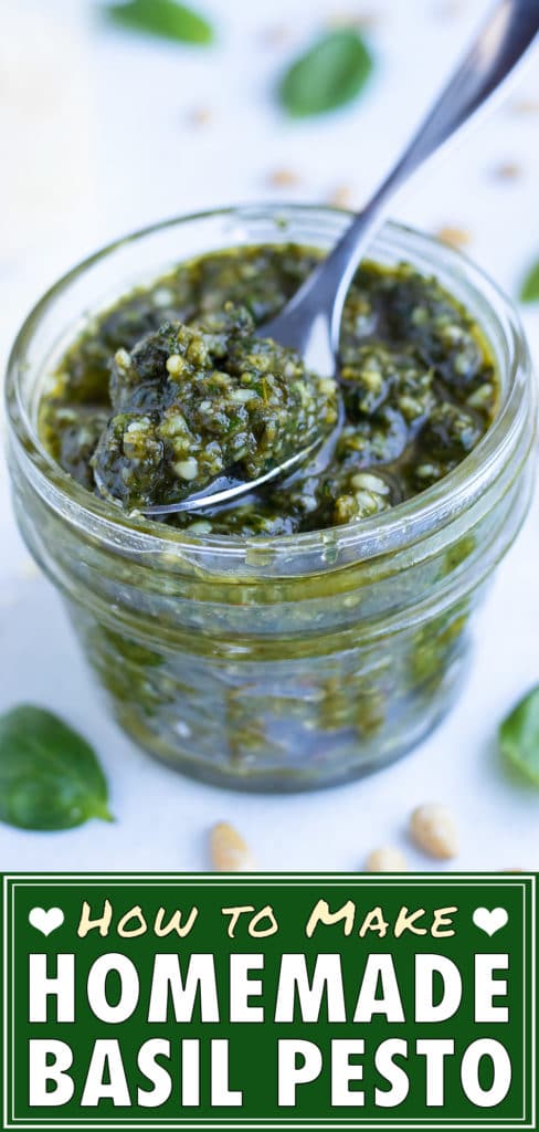 A metal spoon is lifting some healthy, fresh basil sauce.