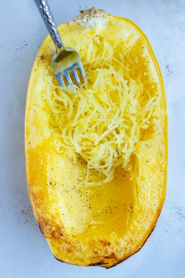 Spaghetti squash is baked in the oven for a vegan side dish.