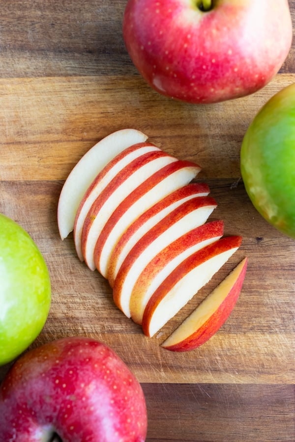 Fresh apple slices are laid on the counter before adding to apple pie or oatmeal.