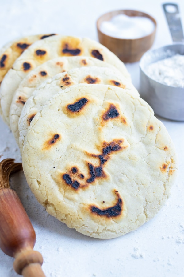 This no yeast, Mediterranean pita bread is stacked on the counter before enjoying.
