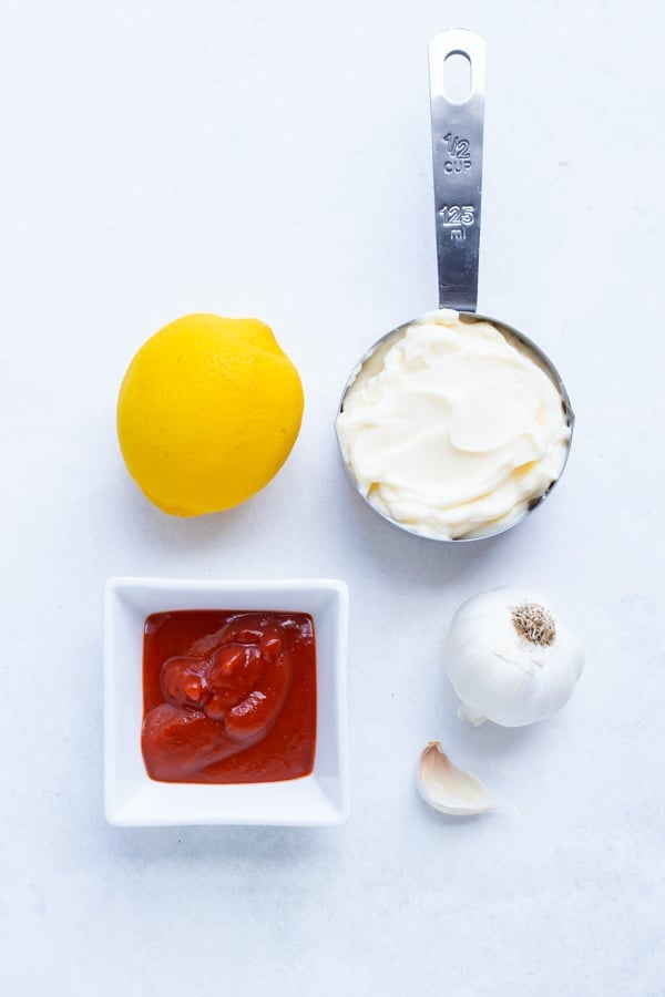 Mayonnaise, Sriracha, garlic, and lemon juice are the ingredients needed for this homemade Sriracha Mayo recipe.