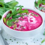Gluten-free beet soup is served in a bowl as an appetizer or side dish.
