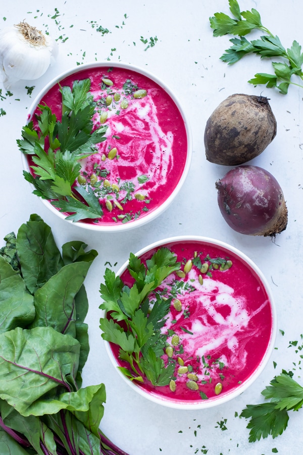 Beet soup is topped with crunchy seeds and coconut milk for a winter dish.