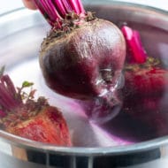 Beets are removed from the pot of water after being boiled.