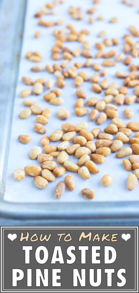 Roasted pine nuts are made on parchment paper and toasted in the oven.