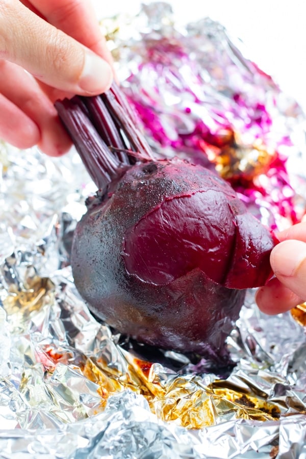 Using your fingers, easily peel back the skin on the roasted beets.