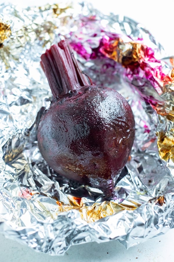 Whole beets are roasted in the oven using aluminum foil.