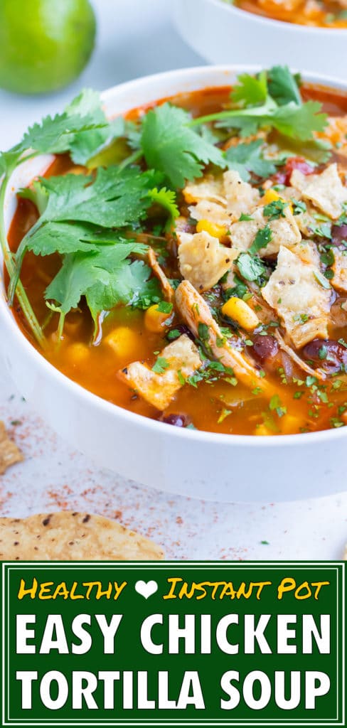 Pressure cooker chicken tortilla soup is topped with fresh cilantro and tortilla chips.