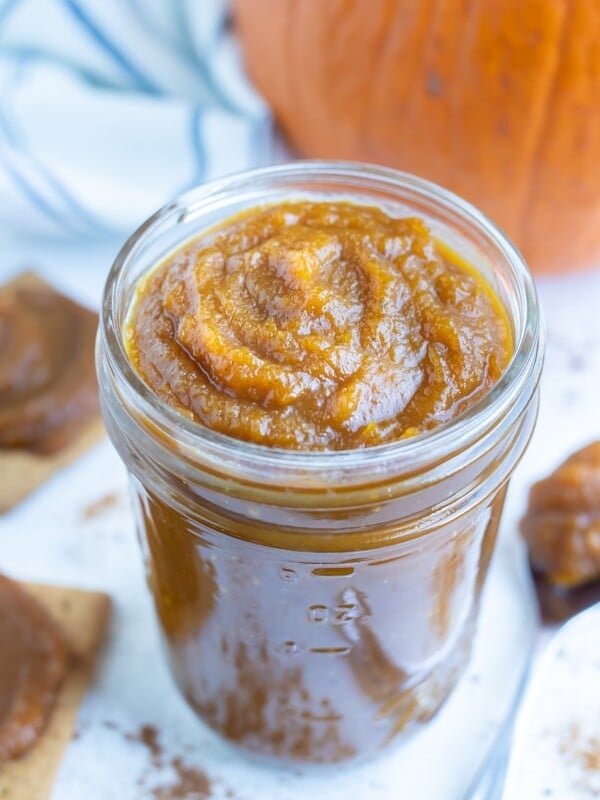 Pumpkin butter is kept in a jar before spreading on bread or crackers.