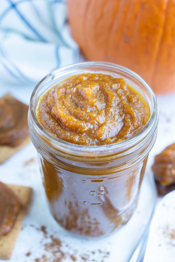 Pumpkin butter is kept in a jar before spreading on bread or crackers.