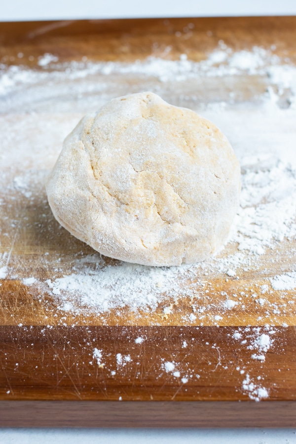 Dough is divided into half and shaped into a ball to rest.