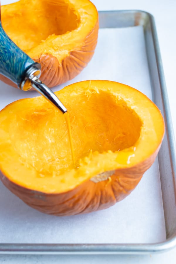 Oil is drizzled over the pumpkin before roasting in the oven.