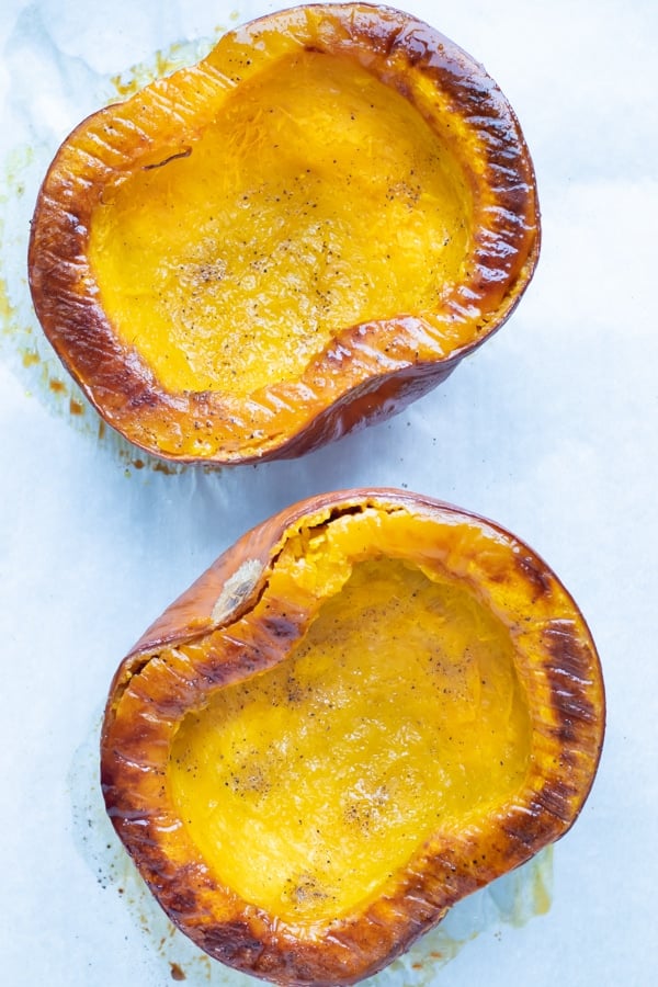 Pumpkins are baked in the oven until the edges are caramelized.