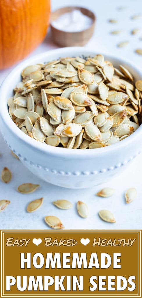 Roasted pumpkin seeds are kept in a white bowl after baking in the oven.