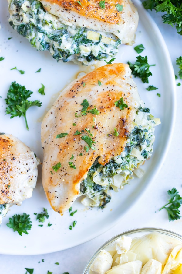 This easy stuffed chicken breast recipe is served on a plate for a dinner party.