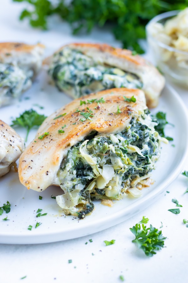 Healthy spinach artichoke stuffed chicken is served at your next dinner party.