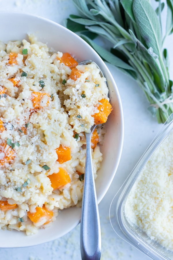 Italian butternut squash risotto is eaten with a spoon.