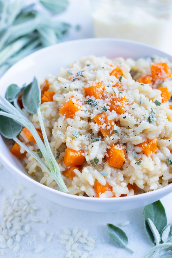 Creamy butternut squash risotto is served in a bowl for dinner.